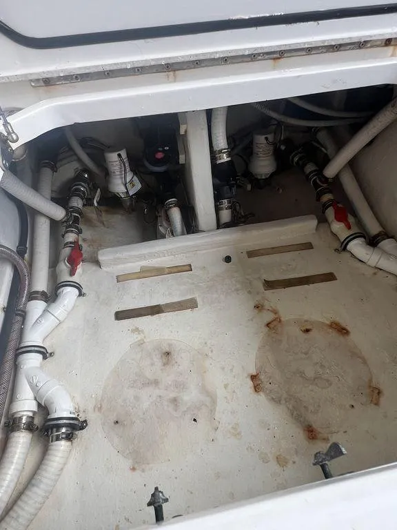 Slide: The Image of 2018 Fountain 38CC LS boat bilge area with visible plumbing and fittings. - 34