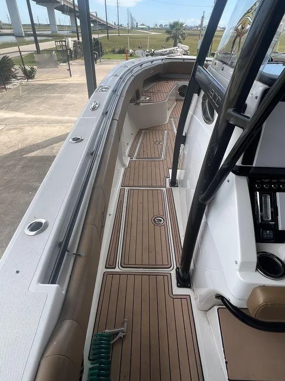 Slide: The Image of 2018 Fountain 38CC LS boat with teak deck and modern controls. - 37