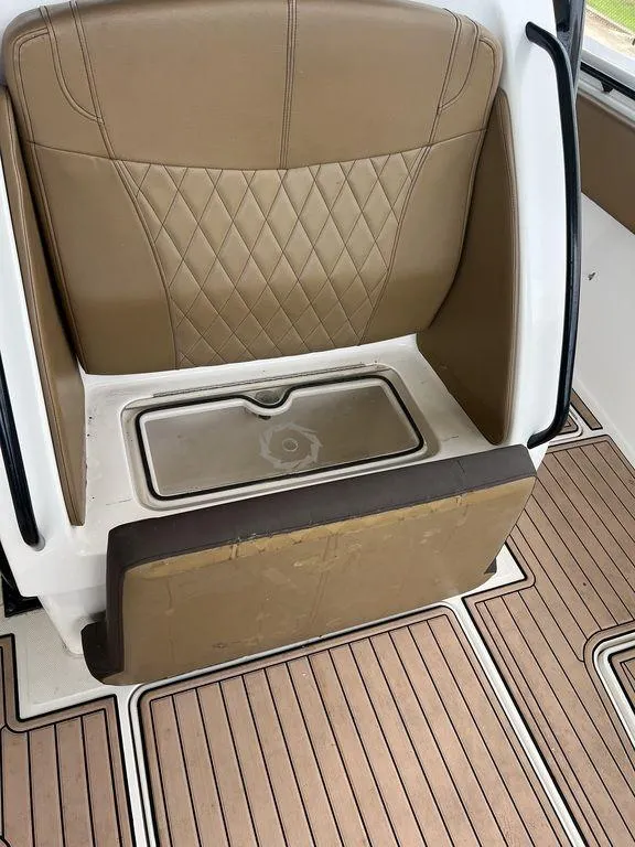 Slide: The Image of 2018 Fountain 38CC LS boat interior with tan seating and wood-patterned flooring. - 39