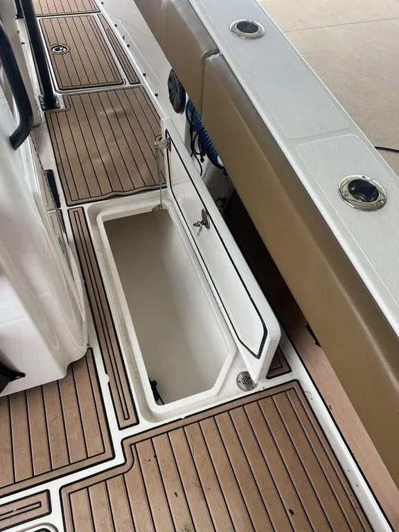 Slide: The Image of 2018 Fountain 38CC LS boat deck with open storage compartment. - 40