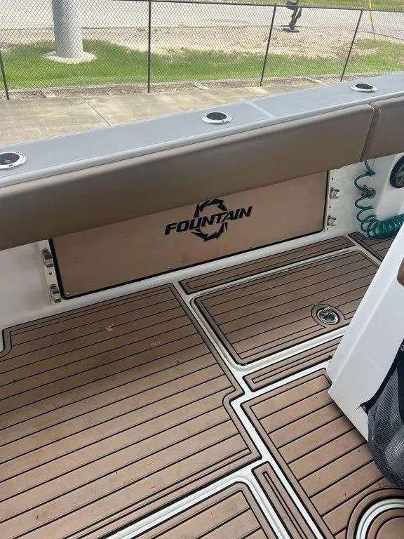 Slide: The Image of 2018 Fountain 38CC LS boat deck with logo and wood finish. - 41