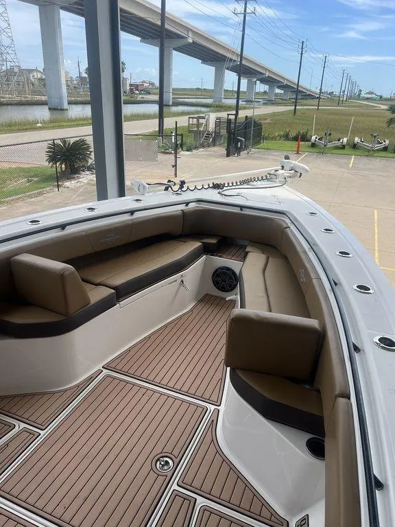 Slide: The Image of 2018 Fountain 38CC LS boat with spacious seating and modern design near a bridge. - 44