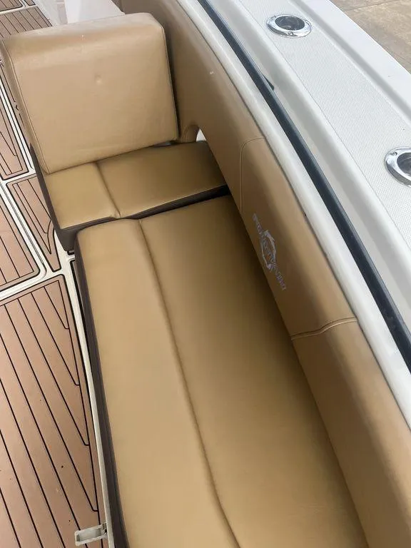 Slide: The Image of 2018 Fountain 38CC LS boat interior with tan leather seating and wood-style flooring. - 46