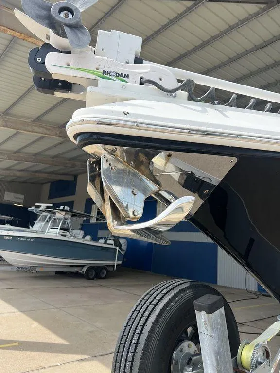 Slide: The Image of 2018 Fountain 38CC LS boat with anchor, parked in a covered marina. - 6