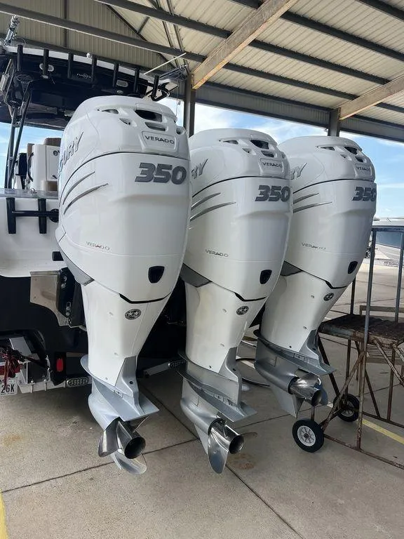 Slide: The Image of 2018 Fountain 38CC LS with triple 350 horsepower outboard engines in a covered dock. - 8