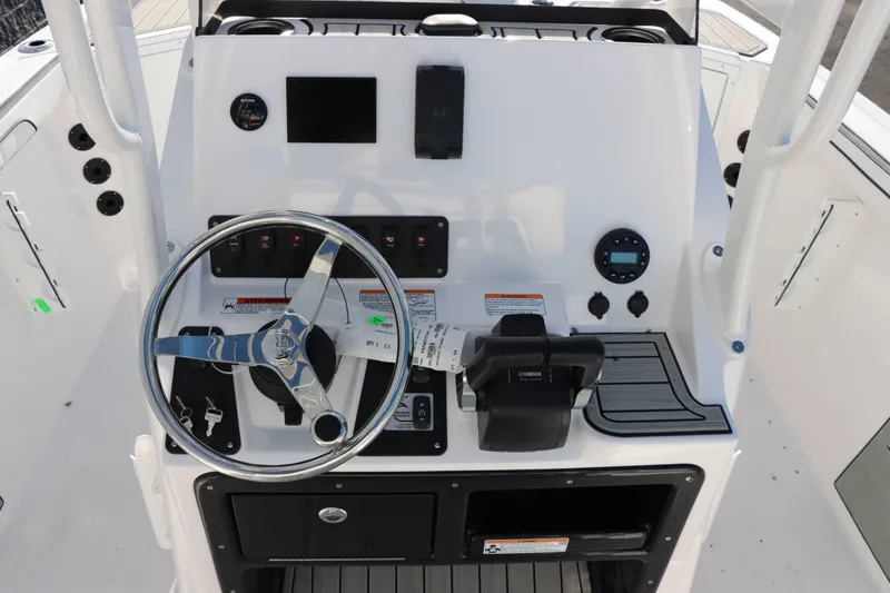 Slide: The Image of 2025 Yamaha Boats 222 FSH Sport dashboard with steering wheel and controls. - 12