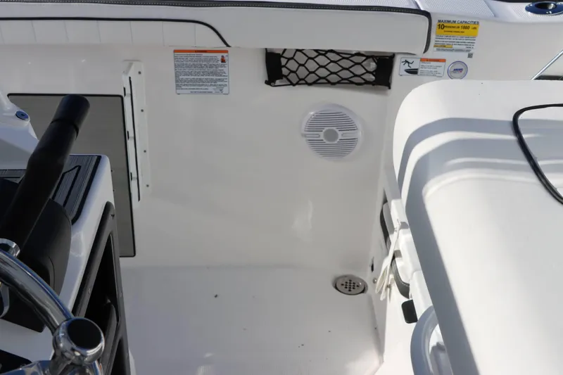Slide: The Image of Interior view of 2025 Yamaha Boats 222 FSH Sport, featuring steering and seating area. - 14