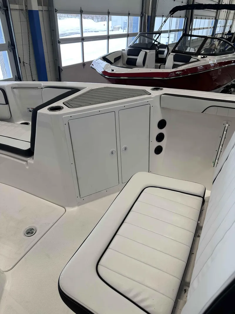 Slide: The Image of 2025 Yamaha Boats 222 FSH Sport interior with white seating and storage compartments. - 18