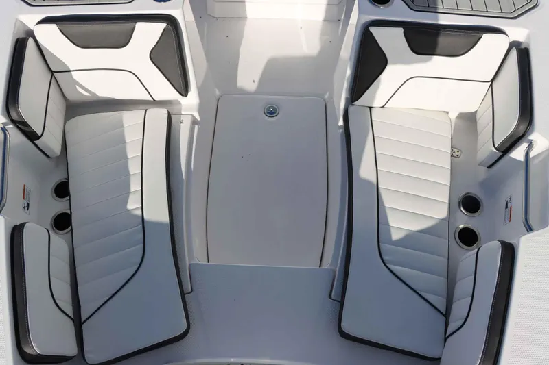 Slide: The Image of 2025 Yamaha Boats 222 FSH Sport interior seating with sleek white and black design. - 20