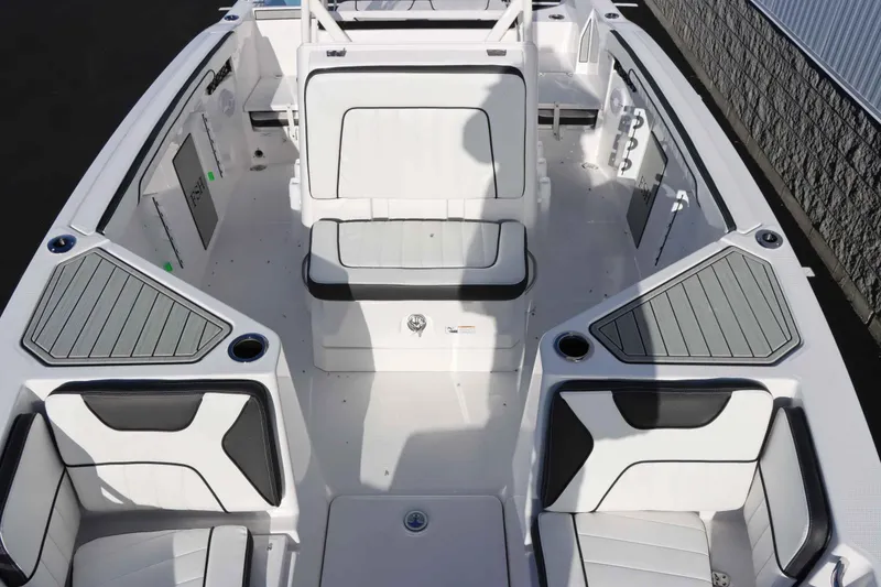 Slide: The Image of 2025 Yamaha Boats 222 FSH Sport interior, featuring sleek white seating and modern design. - 24