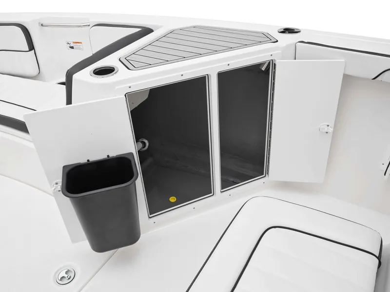 Slide: The Image of 2025 Yamaha Boats 222FSH SPORT interior storage compartment with open doors and trash bin. - 34
