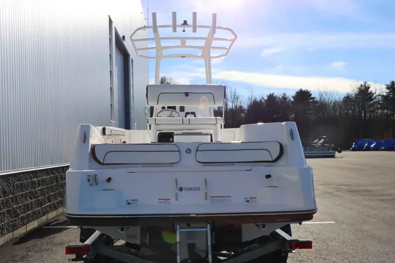 Slide: The Image of 2025 Yamaha Boats 222 FSH Sport, rear view, parked outdoors. - 5