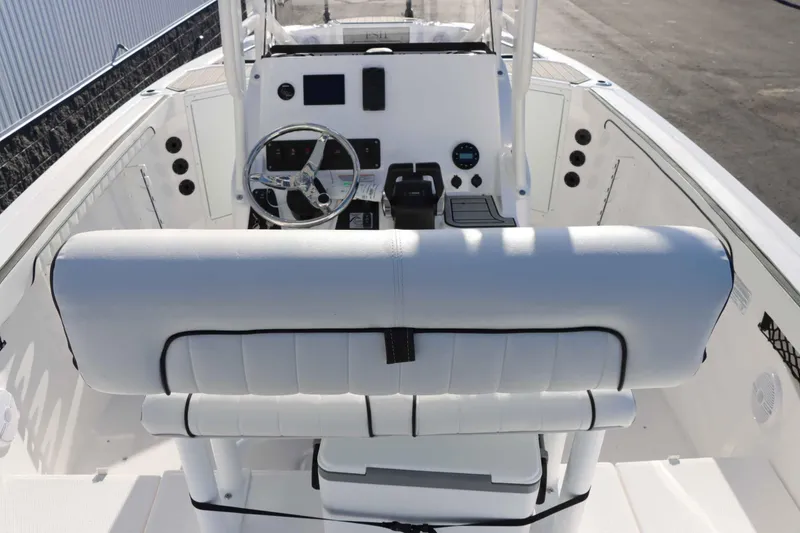 Slide: The Image of 2025 Yamaha Boats 222 FSH Sport interior with steering console and seating. - 8