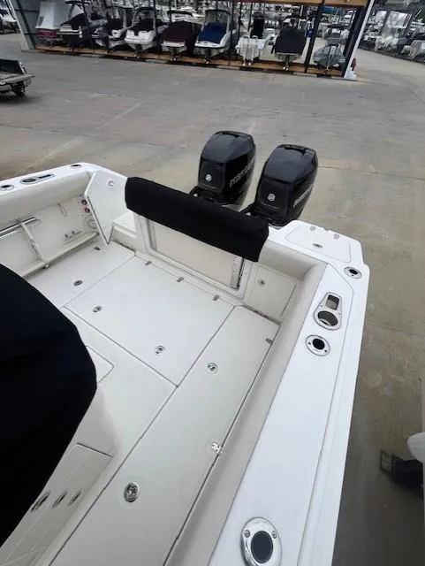 Slide: The Image of 2020 Boston Whaler 280 Outrage boat with dual engines, docked at a marina. - 10