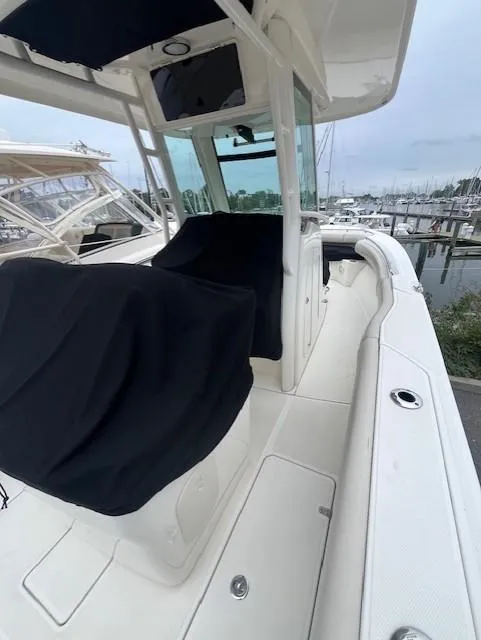 Slide: The Image of 2020 Boston Whaler 280 Outrage boat docked at marina, featuring sleek design and spacious deck. - 14