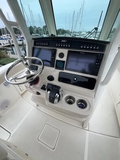 Slide: The Image of 2020 Boston Whaler 280 Outrage helm with advanced navigation controls and dual displays. - 18