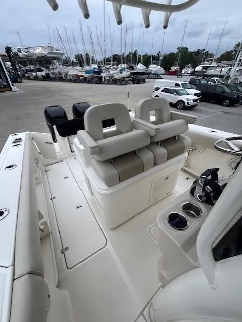 Slide: The Image of 2020 Boston Whaler 280 Outrage boat interior with seating and marina view. - 23