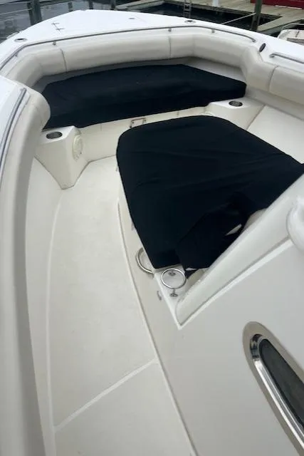 Slide: The Image of 2020 Boston Whaler 280 Outrage boat interior with cushioned seating and cup holders. - 24