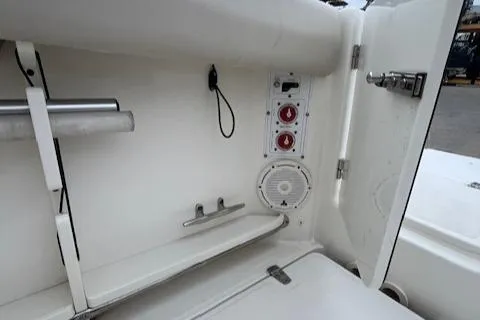 Slide: The Image of Boston Whaler 280 Outrage 2020 boat interior with storage compartment and controls. - 29