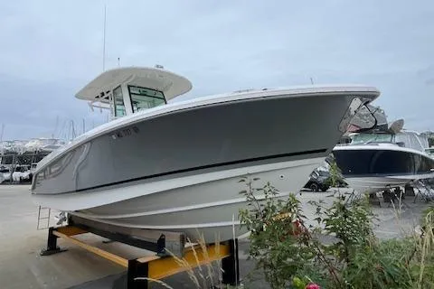Slide: The Image of 2020 Boston Whaler 280 Outrage boat on display in a marina setting. - 6