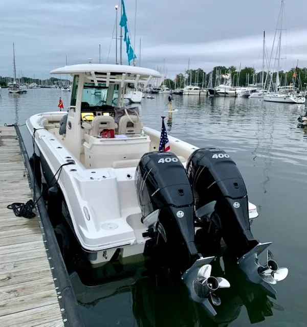 Slide: The Image of 2020 Boston Whaler 280 Outrage docked, featuring dual 400 horsepower engines. - 8