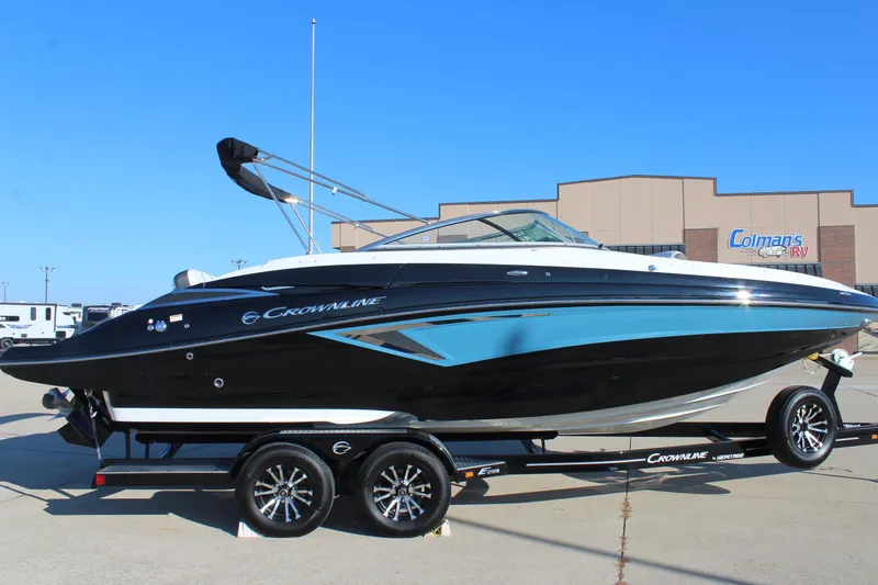 The Image of 2024 Crownline Eclipse E255 boat on trailer, displayed outdoors at dealership. - 0