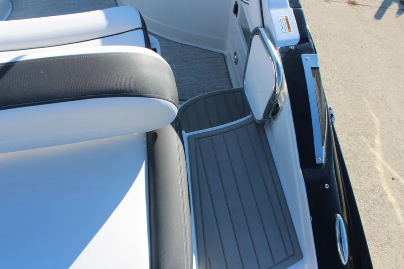 Slide: The Image of 2024 Crownline Eclipse E255 boat dashboard with steering wheel and control panel. - 21