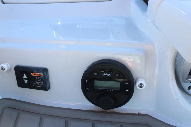 Slide: The Image of 2024 Crownline Eclipse E255 boat interior storage compartment with cup holders. - 32