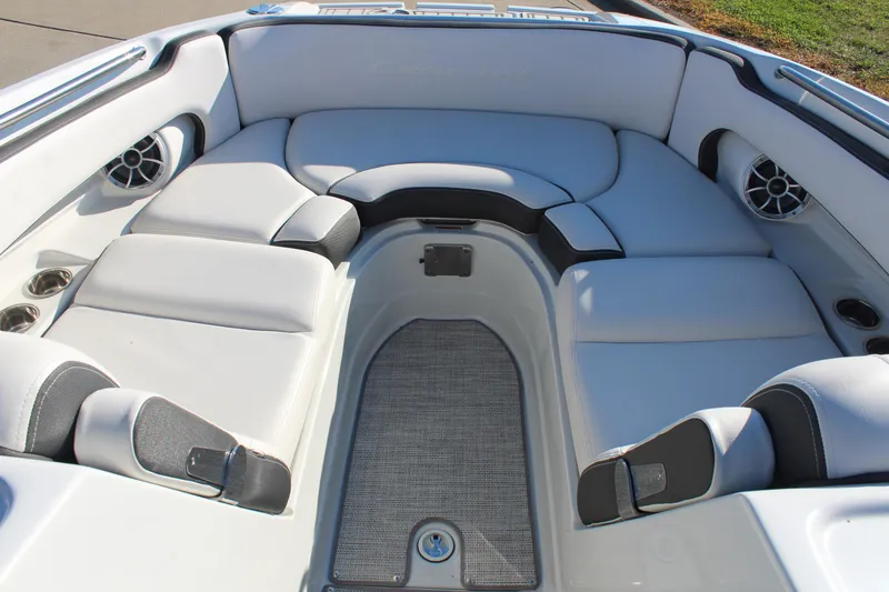 Slide: The Image of 2024 Crownline Eclipse E255 boat on trailer, black and blue design, parked outdoors. - 5