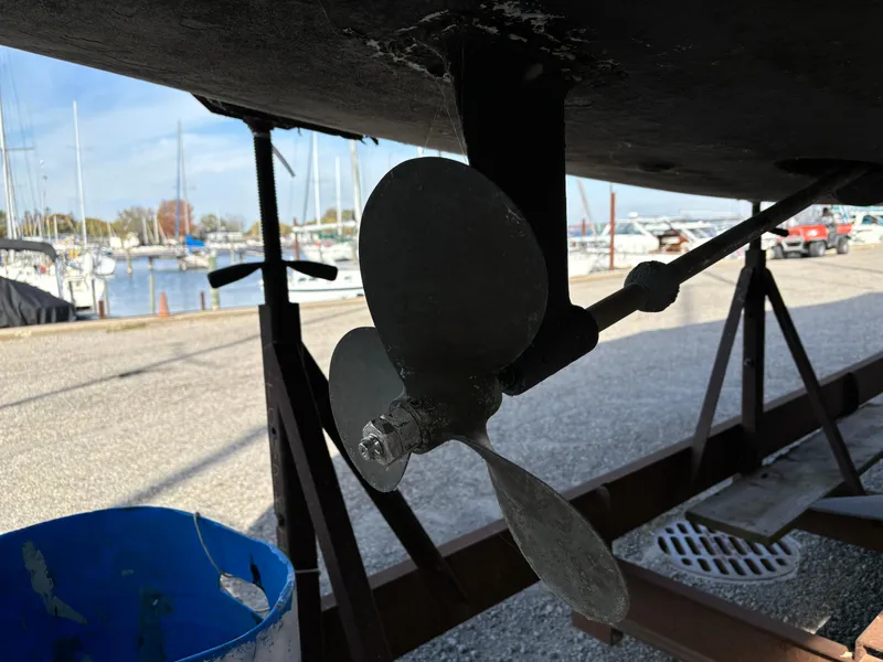 Slide: The Image of Propeller of a 2001 Hunter 320 sailboat on a stand at a marina. - 10