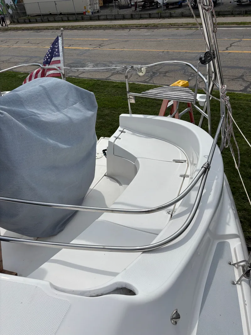 Slide: The Image of Hunter 320 sailboat deck, 2001 model, with American flag and covered equipment. - 15