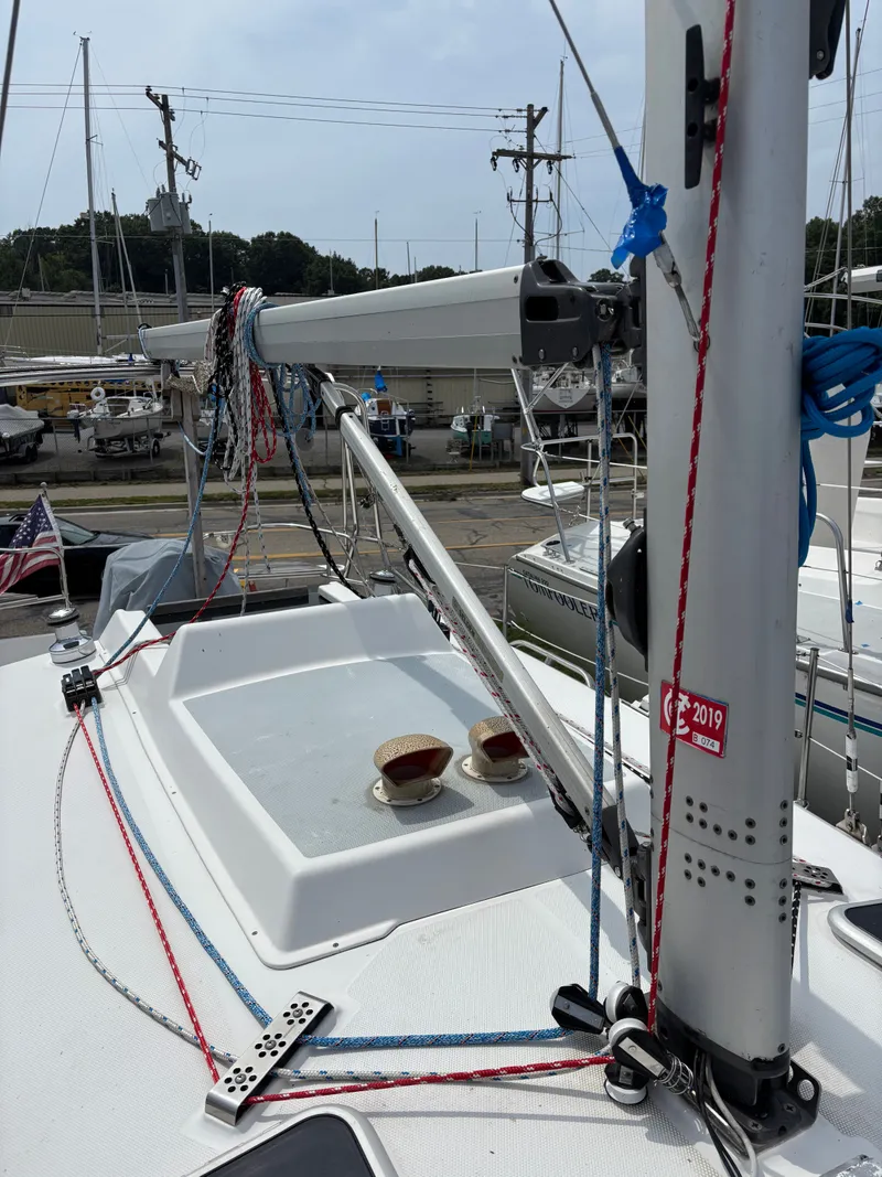 Slide: The Image of 2001 Hunter 320 sailboat deck with rigging and mast in a marina setting. - 21