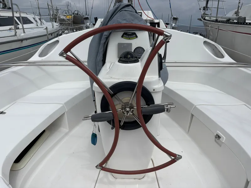 Slide: The Image of Cockpit of a 2001 Hunter 320 sailboat with a unique steering wheel design. - 25