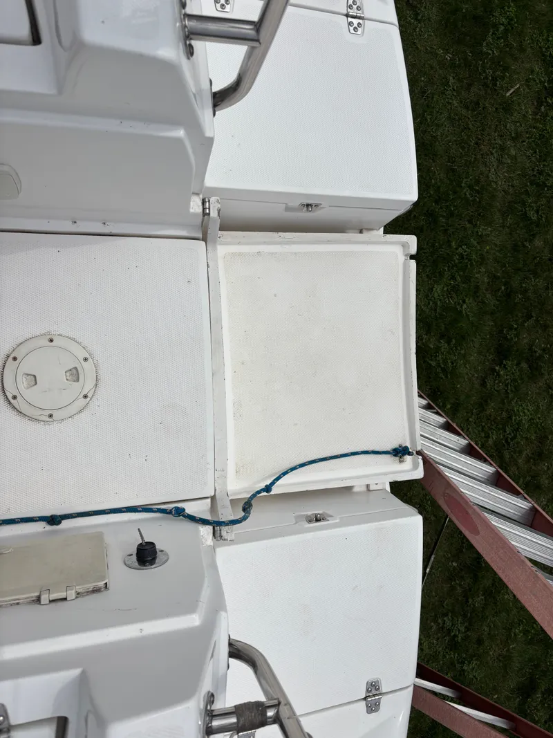 Slide: The Image of Deck view of a 2001 Hunter 320 sailboat with white surfaces and blue rope. - 31