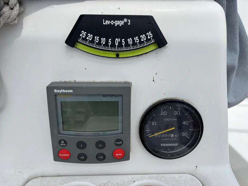 Slide: The Image of Control panel of a 2001 Hunter 320 sailboat with autopilot and engine gauges. - 34