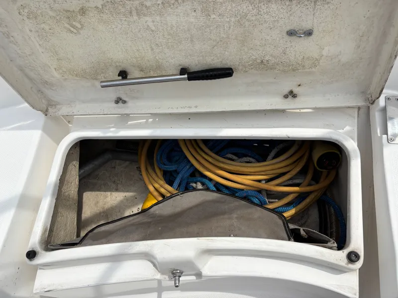 Slide: The Image of Storage compartment on a 2001 Hunter 320 sailboat with coiled ropes and cables. - 35