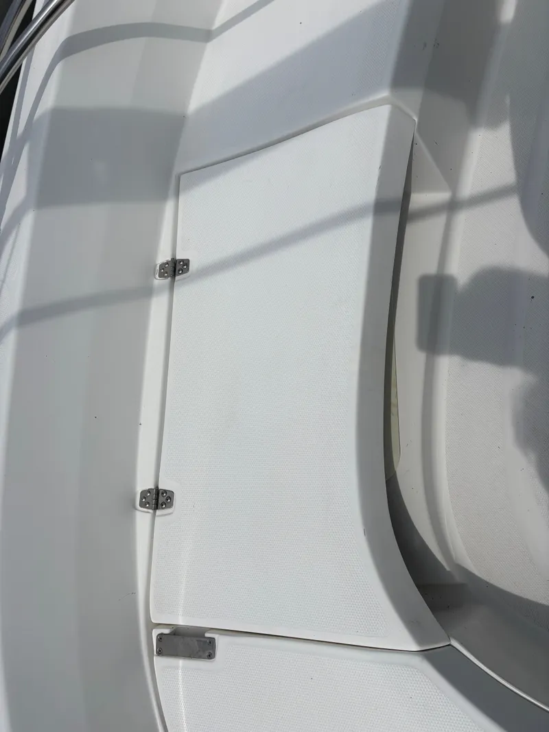 Slide: The Image of White deck of a 2001 Hunter 320 sailboat, featuring a hinged compartment. - 37
