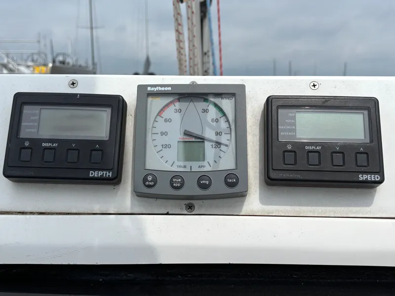 Slide: The Image of Instrument panel on a 2001 Hunter 320 sailboat showing depth, wind, and speed gauges. - 39