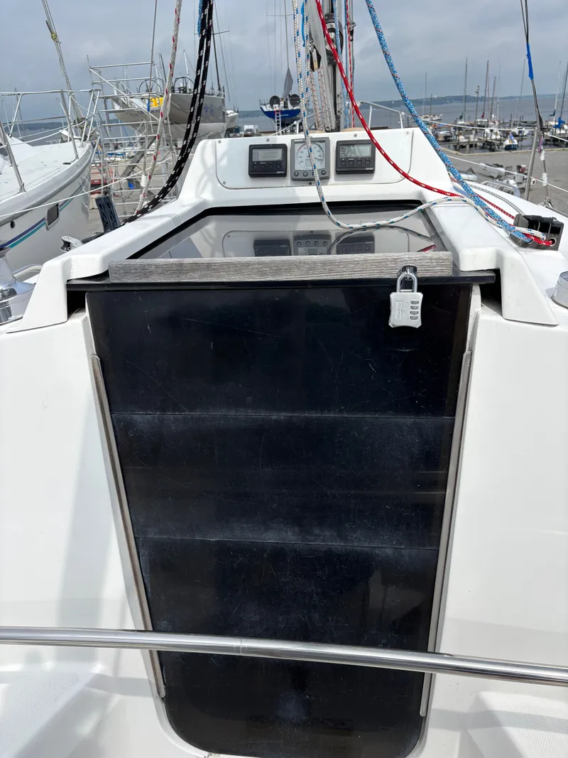 Slide: The Image of Sailboat cockpit of a 2001 Hunter 320 with secured hatch and visible rigging. - 40