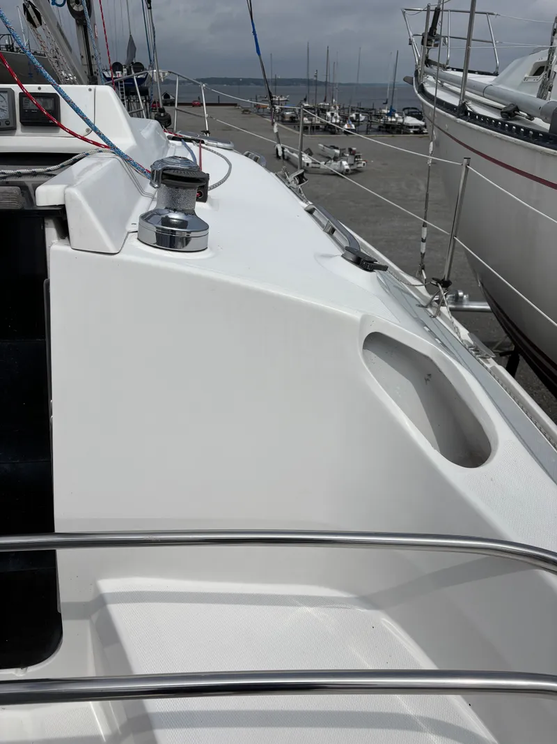 Slide: The Image of 2001 Hunter 320 sailboat deck with winch and railing, docked at marina. - 41