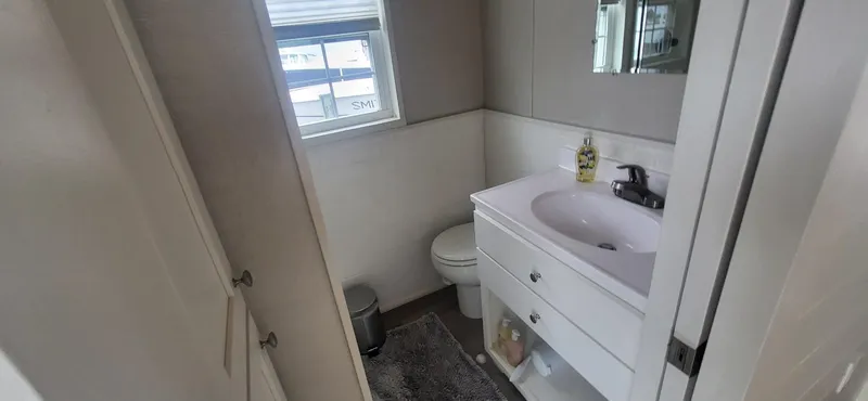 Slide: The Image of Bathroom interior of 2020 Destination Yachts 16x45 Condo Series, featuring sink and toilet. - 15