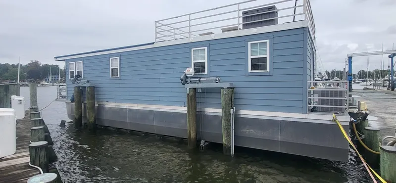 Slide: The Image of 2020 Destination Yachts 16x45 Condo Series houseboat docked at marina. - 28