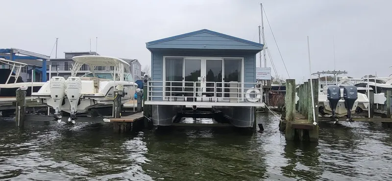 Slide: The Image of 2020 Destination Yachts 16x45 Condo Series houseboat docked at marina. - 30