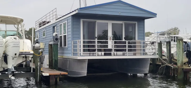 The Image of 2020 Destination Yachts 16x45 Condo Series houseboat docked at marina. - 0