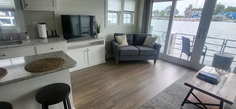 Slide: The Image of 2020 Destination Yachts 16x45 Condo Series interior with modern decor and waterfront view. - 10