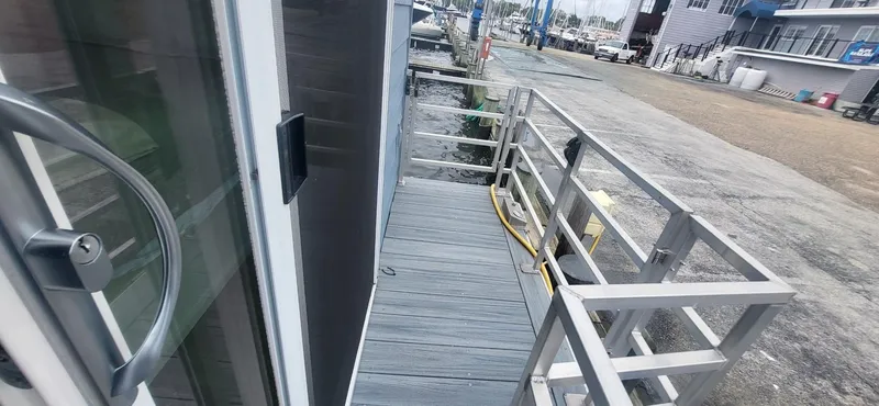 Slide: The Image of 2020 Destination Yachts 16x45 Condo Series docked at marina, side view. - 17