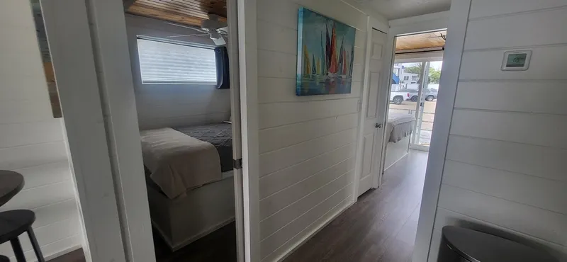 Slide: The Image of Interior of 2020 Destination Yachts 16x45 Condo Series, featuring modern design and cozy bedroom. - 18