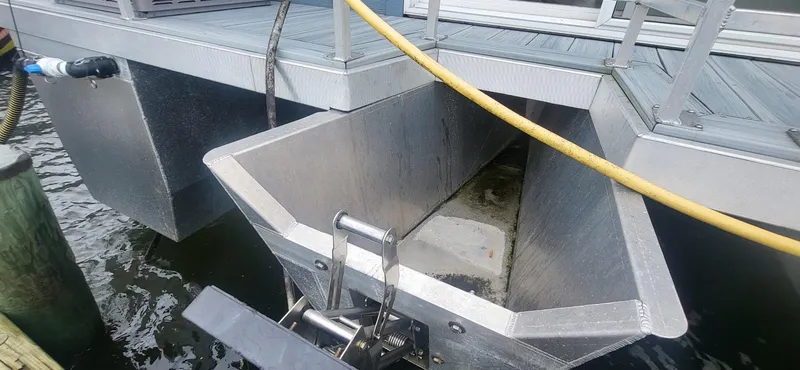 Slide: The Image of 2020 Destination Yachts 16x45 Condo Series houseboat hull detail at dock. - 29