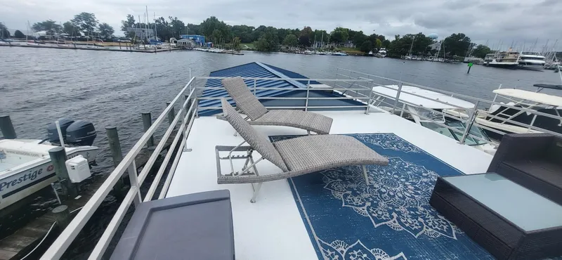 Slide: The Image of Rooftop deck of 2020 Destination Yachts 16x45 Condo Series with lounge chairs and scenic water view. - 3