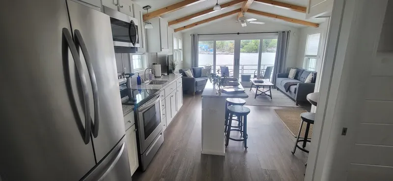 Slide: The Image of Modern kitchen and living area in 2020 Destination Yachts 16x45 Condo Series houseboat. - 6